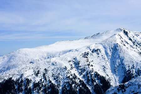 Beautiful mountains covered in snow at winterの写真素材