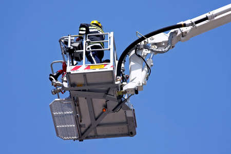 Fire fighter in big and tall crane の写真素材
