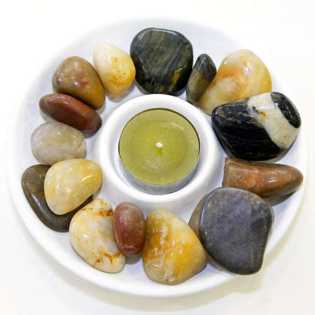 Aromatic candle and decorative spa stones mineralsの写真素材