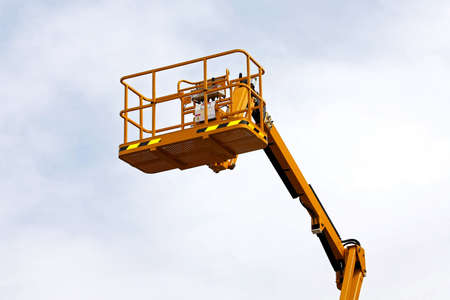 Yellow construction platform bucket for high works