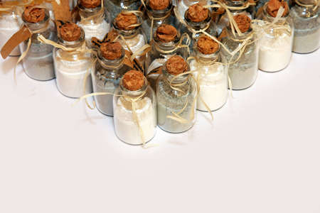 Bunch of small glass jars with powderの写真素材