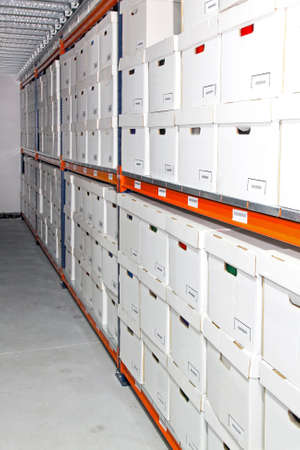 Long rack with white boxes in warehouseの写真素材