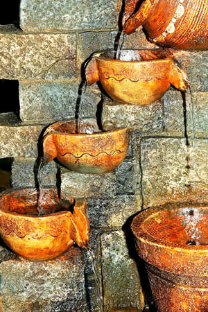 Close up shot of old pots fountainの写真素材