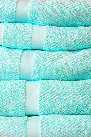 Pile of fresh and soft bath towelsの写真素材