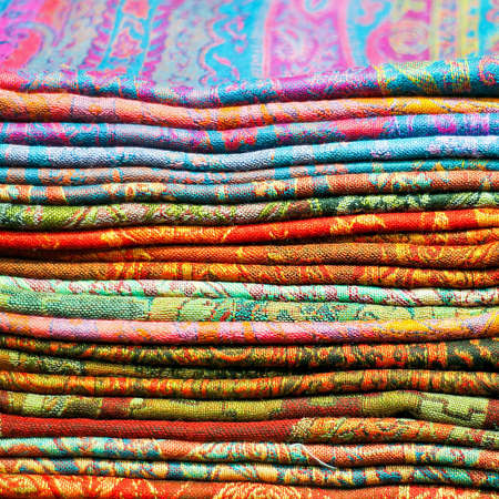 Big pile of colorful Asian silk scarvesの写真素材