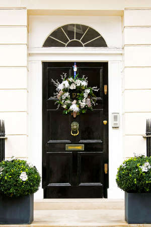 Christmas wreath with pine cones at doorの写真素材