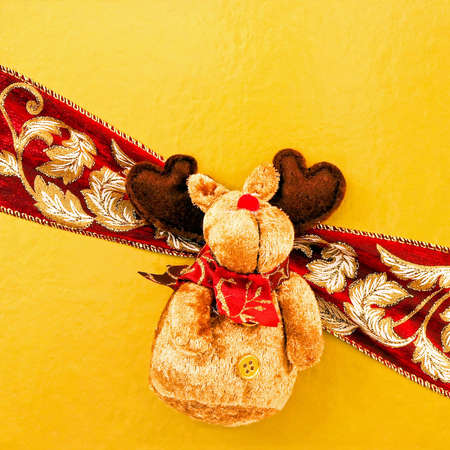 Red nose reindeer with wrap at gold giftの写真素材