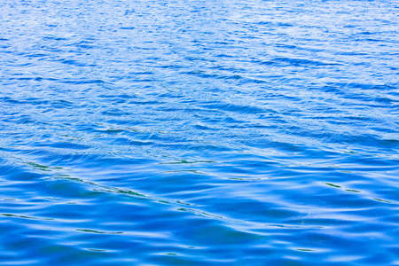 Blue and clean water surface with few ripples