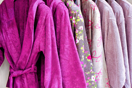 Several soft and warn bathrobe in closetの写真素材