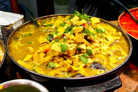 Freshly prepared chicken dish on a market stallの写真素材