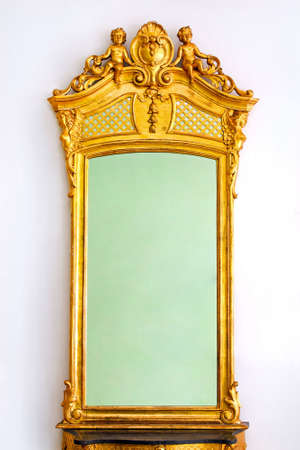 Antique gold mirror with angel figures on topの写真素材