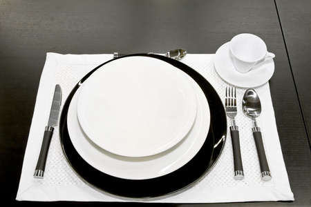 Porcelain dishes with tableware at black table
の写真素材