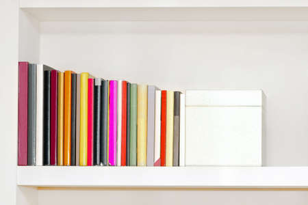 Bookshelf on the wall with colorful booksの写真素材