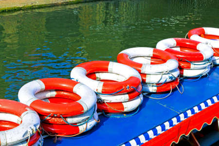 Bunch of life rings on boat in the riverの写真素材