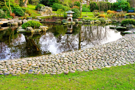 Blissful Japanese garden with pebble path and lakeの写真素材