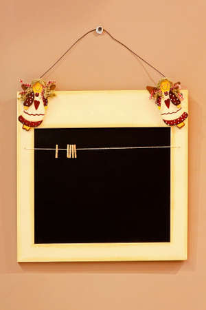 Retro black board hanging on the wallの写真素材