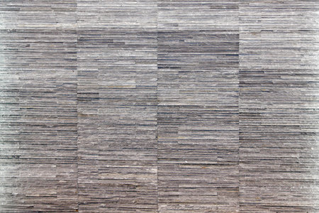 Gray stone wall with natural mineral tiles 