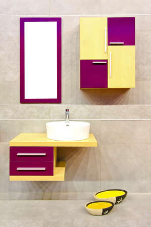 Colorful bathroom cabinets and white ceramic wash basin の写真素材