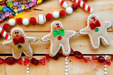 Christmas arrangement with colorful ornaments in the shape of gingerbread candy の写真素材
