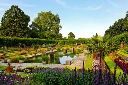Beautiful botanic garden with flowers and pond の写真素材
