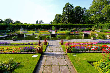 Beautiful botanic garden with flowers and pond の写真素材
