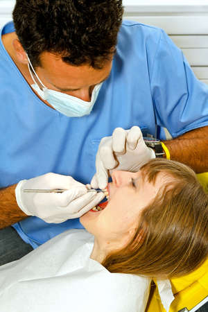 Girl at dental office during teeth exam の写真素材