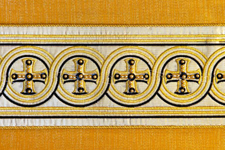 Golden cross pattern at traditional Catholic dress 