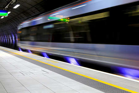 Modern speed train moving through underground station 