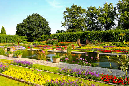 Beautiful botanic garden with flowers and pond の写真素材