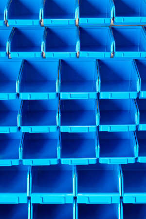 Blue plastic open box organizer in storehouse 