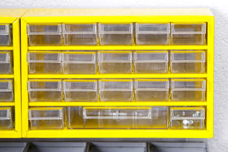 Yellow shelf for parts inventory in workshop の写真素材