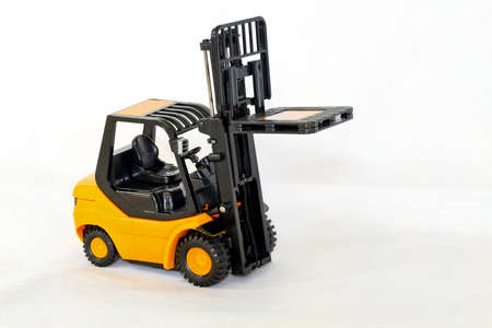 Small forklift vehicle with pallet in fork 