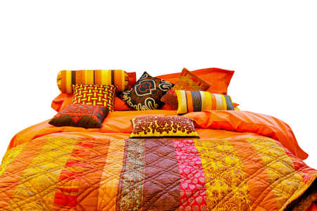 Big bed with colourful blanket and pillows 