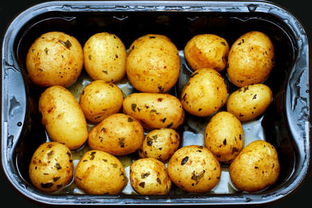 Prepared small potatoes in plastic microwave pot の写真素材