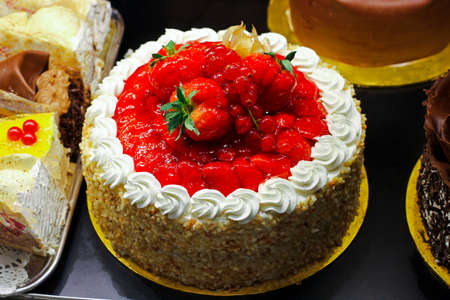 Tasty fruit cake with strawberry decoration on top の写真素材