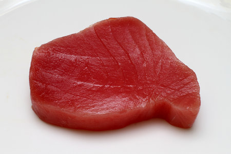 Fresh and raw tuna steak at plateの写真素材