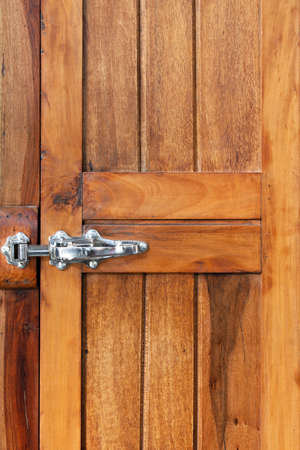 Old brown wood door with metal lockの写真素材