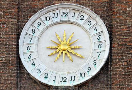 Medieval time 24 hours clock with golden sunの写真素材