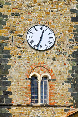 Medieval castle tower with clock in Italy