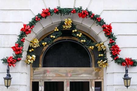 Arch door with Christmas pendants and ribbon decorの写真素材