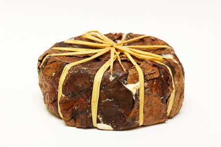 Old French goat cheese with leaf wrappingの写真素材