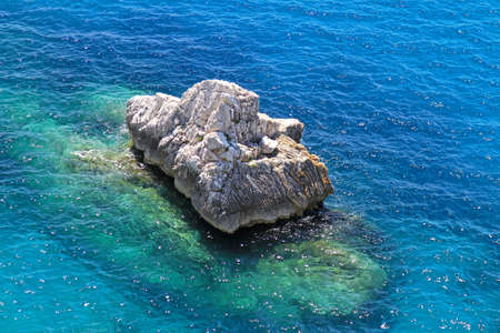 Aerial view of big rock in blue Adriatic sea