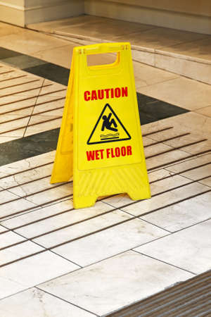 Yellow caution sign for wet floor warningの写真素材