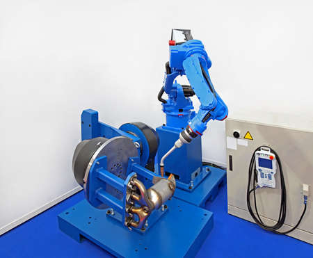 Robot welder manufacturing car parts in factory