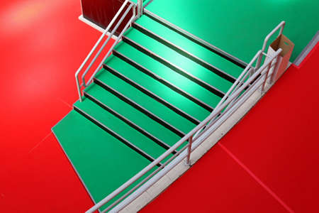 Green stairway and red carpet from aboveの写真素材