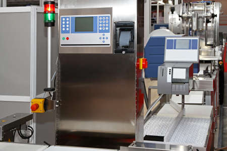 Modern packaging machine at production line in factory