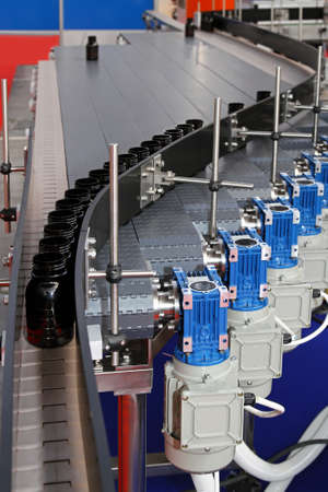 Automated conveyor belt with bottles at production line