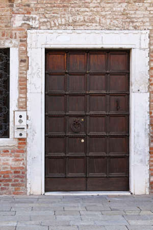 Wooden door at medieval house in Veniceの写真素材