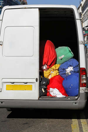Laundry cleaning service delivery van with bagsの写真素材