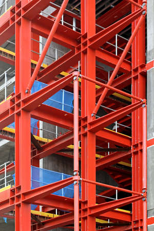Red metal scaffold equipment at construction siteの写真素材
